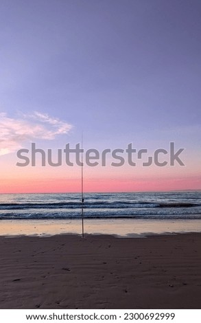 Picture of Mediterranean sea waves at sunset in Tangier, Morocco.  People exercising in the sand.