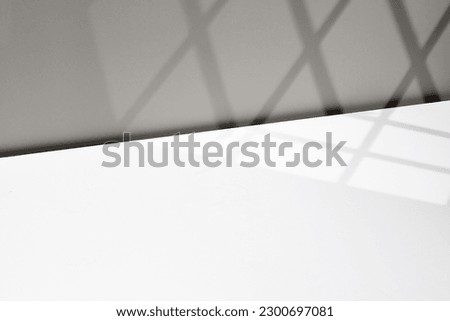 Empty white background with window shadow, sunlight, sun. Template for advertising, presentation, cosmetic products. Photography. Diagonal scene.