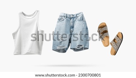 Trendy flying cotton tank top, blue jeans shorts, vegan cork sandals isolated on gray background. Clean white crop top. Branding clothes. Mock up for your design. Spring Summer Women's Clothing.