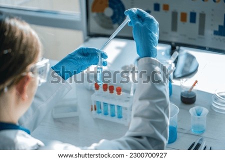 Experiment in chemical laboratory to develop new drugs to treat cardiovascular disease. Scientist biologist conducting experiments with cells and tissues in biotechnology laboratory Royalty-Free Stock Photo #2300700927