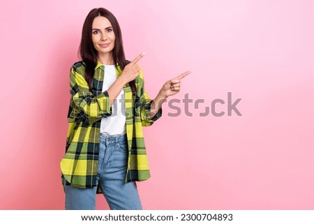Portrait of funny friendly person long hairstyle yellow jacket indicating at proposition empty space isolated on pink color background