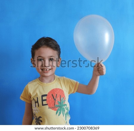 Cute Boy Holding Gray Balloon
