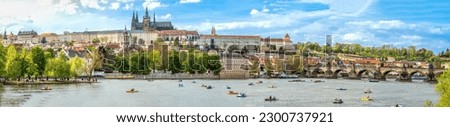 A panoramic view of Prague, the capital of the Czech Republic. View of Prague Castle and Charles Bridge. Summer time, people swim on catamarans. banner Royalty-Free Stock Photo #2300737921