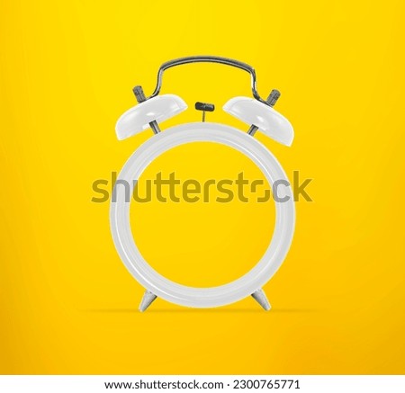 Living coral alarm clock with empty face, no hands, on yellow background. Minimal creative concept. Copy space Royalty-Free Stock Photo #2300765771