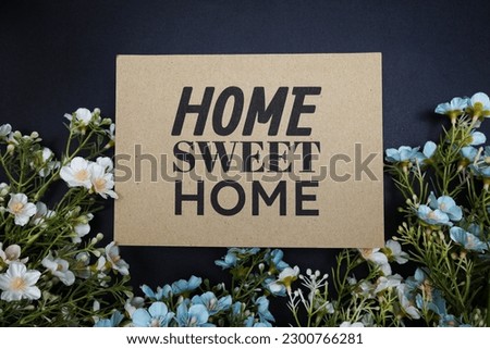 Home Sweet Home text message with flower decoration on black background