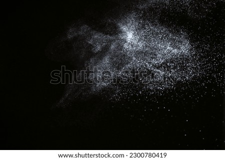 Natural dust particles flow in air on black background Royalty-Free Stock Photo #2300780419