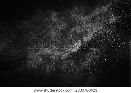 Natural dust particles flow in air on black background Royalty-Free Stock Photo #2300780421