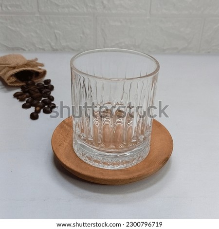 Traditional greek cold coffee Frappe with foam made from water, instant coffee and salt, maple syru,  ice cubes in glass close up.
