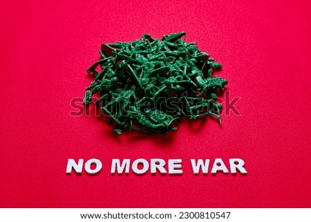 "NO MORE WAR" and toy soldiers on a red background.