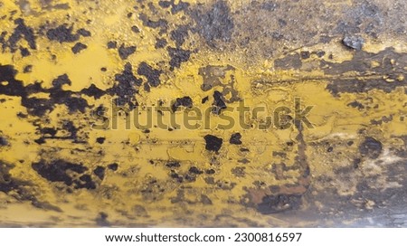 High-resolution Stock Photos of a metal Surface with a worn yellow paint texture that's been rusted over time creating a unique and rustic texture perfect for backgrounds, textures, Industrial design.