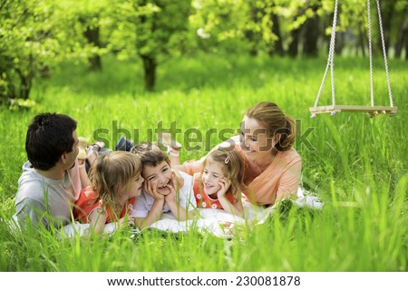 Happy family having picnic in nature Royalty-Free Stock Photo #230081878