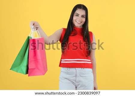 Young Indian Shopaholic Girl Posing with Shopping Bags in Left Hand - Smiling Woman After Purchasing Items from Store