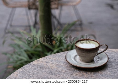 A cup of Matcha Latte with beautiful Latte Art. Bokeh or blurred background. Soft focus or unfocused.