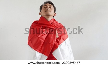 Soccer fan with the flag of his country Indonesian, on a white background.