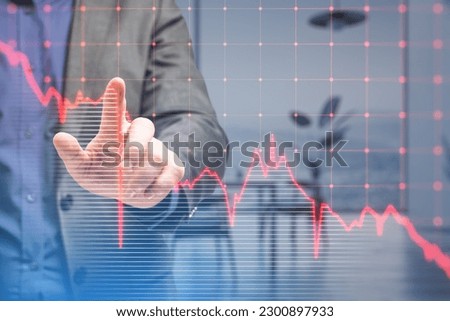 Close up of businessman hand pointing at falling red business graph grid on blurry office interior background. Crisis, recession and stock market concept. Double exposure