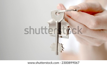 keys with a keychain in hand, the concept of buying a home. High quality photo