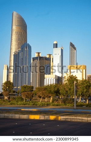 a beautiful picture of dubai city street side with buildings and hotels under a blue sky in afternoon time