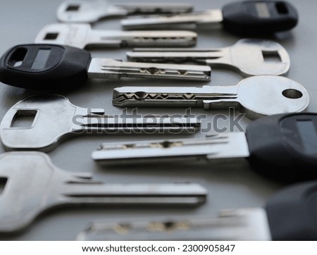 Laid out one by one modern lock keys angle view extreme closeup stock photo 