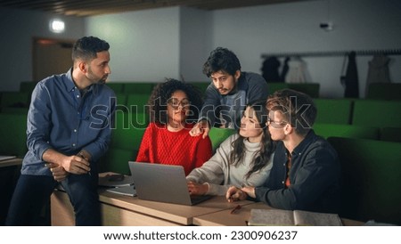 Group of Multiethnic Enthusiastic Students Comparing Research Findings in University Study Room. Young Doctorate Researcher Joining the Conversation with Colleagues Royalty-Free Stock Photo #2300906237