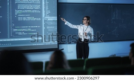 Portrait of a Young University Professor Explaining the Importance of Artificial Intelligence to a Group of Diverse Students. Female Teacher Showing Big Data Ecosystem on a Big Screen Royalty-Free Stock Photo #2300906297