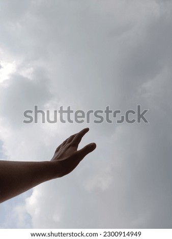 dark hands facing the sky