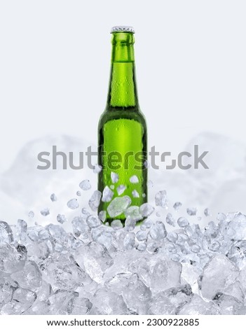 Green bottle of fresh beer with drops floats up through the ice cubes Royalty-Free Stock Photo #2300922885