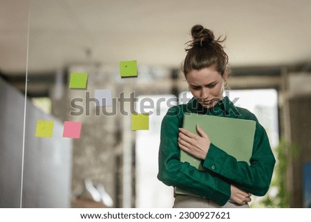 Young sad woman in office, having problem. Royalty-Free Stock Photo #2300927621