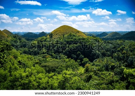 A scenic aerial shot of the Chocolate Hills with dense greenery in Phillippines