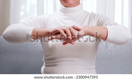 Close up of young woman hands, doing hand massage by herself for soothing and relaxing. Concept of self hand massage.