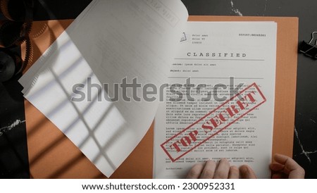 Browse top secret and censored documents Royalty-Free Stock Photo #2300952331