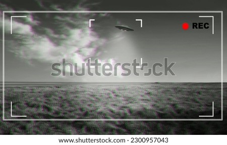 UFO, alien and viewfinder on a camera display to record a flying saucer in the sky over area 51. Camcorder, sighting and conspiracy with a spaceship on a recording device screen outdoor in nature Royalty-Free Stock Photo #2300957043