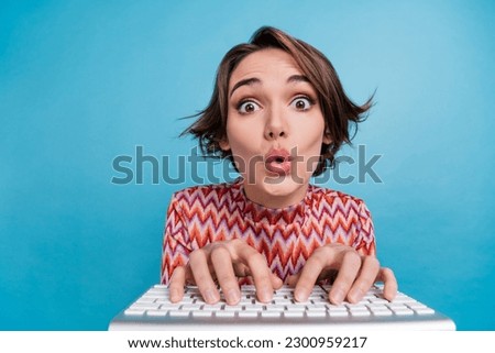 Photo of funky impressed lady wear striped top chatting keyboard big eyes isolated blue color background Royalty-Free Stock Photo #2300959217