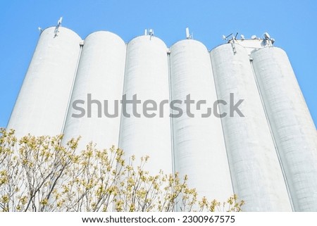 Agricultural concrete silos. Industrial granary, building exterior, storage of grain, wheat, corn, soy, sunflower. Europe in Hungary.                               Royalty-Free Stock Photo #2300967575