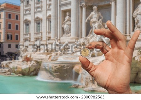 Coin toss at the Trevi Fountain for good luck, Rome Royalty-Free Stock Photo #2300982565