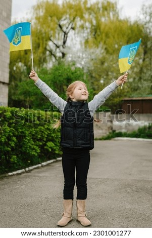 Independence Day. Flag day. Ukrainian flag blue and yellow in hands kid, child. Ukrainians against war. Happy girl closeup. Constitution day. Family, unity, support. No war. Winner.