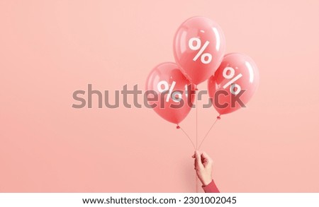 Hand of woman holding pink balloons with percent on pink background, Minimal, Sale and discount. copy space. Royalty-Free Stock Photo #2301002045