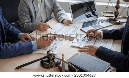 Hard work of Asian lawyers in a lawyer's office . Advise and prosecute conflicts between private and government officials to find a fair settlement. Royalty-Free Stock Photo #2301004629