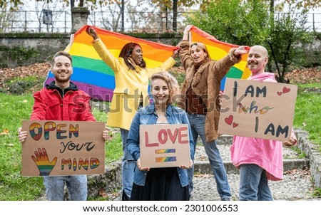 Group of young activist for lgbt rights with rainbow flag and banner, diverse people of gay and lesbian community, gay Pride Parade Royalty-Free Stock Photo #2301006553