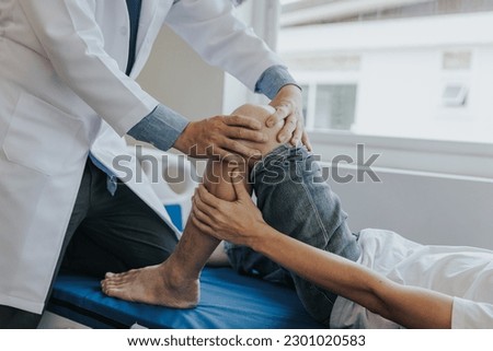 Physiotherapist working with patients in clinic, Royalty-Free Stock Photo #2301020583