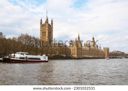 Cruising down the river Thames past Westminster palace the houses of parliament and big ben. High quality photo
