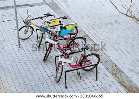 Four parked bikes in the city on the pavement