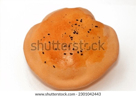 Egyptian Mahlab bread, puff thin, crispy and delicious with black seed baraka seeds on top, made of flour, dry yeast, milk, eggs, sugar, salt, black seeds, warm water, with anything or on its own Royalty-Free Stock Photo #2301042443