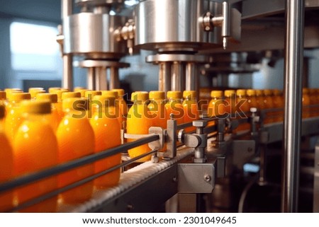 Orange juice factory. Robotic factory line for processing and bottling of orange juice bottles. Selective focus. Royalty-Free Stock Photo #2301049645
