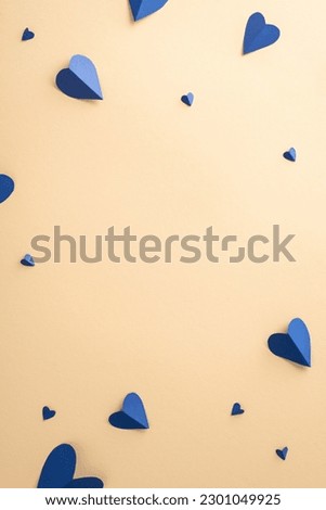Celebrate Father's Day with style! Top view vertical flat lay of paper hearts composition on a beige background with an empty frame for text or advert