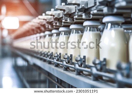 Milk factory. Robotic factory line for processing and bottling of milk. Selective focus. Royalty-Free Stock Photo #2301051191