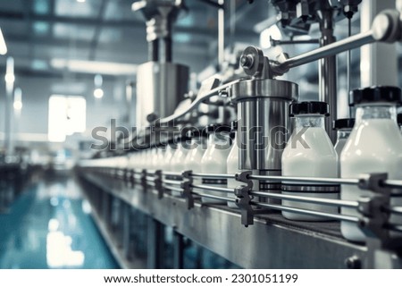Milk factory. Robotic factory line for processing and bottling of milk. Selective focus. Royalty-Free Stock Photo #2301051199