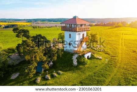 Experience the enchantment of sunset on lookout Tower in Czech Republic with this captivating photo. Illuminating the rolling hills and lush forests, a sense of tranquility and awe fills the air