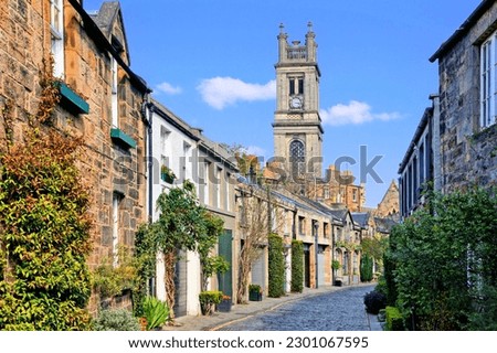 Quaint old residential street with church spire in Edinburgh Scotland during springtime Royalty-Free Stock Photo #2301067595