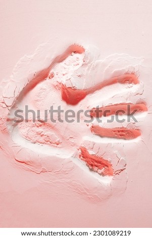 Creative, stunning background of wallpaper featuring a vivid handprint on a beautiful pink sand beach. Creative art photography. Abstract nature background. Design, banner, poster