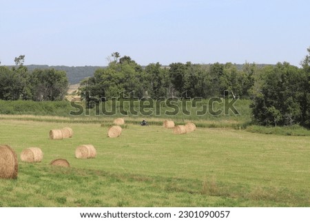 Dirt biking through a field of bails